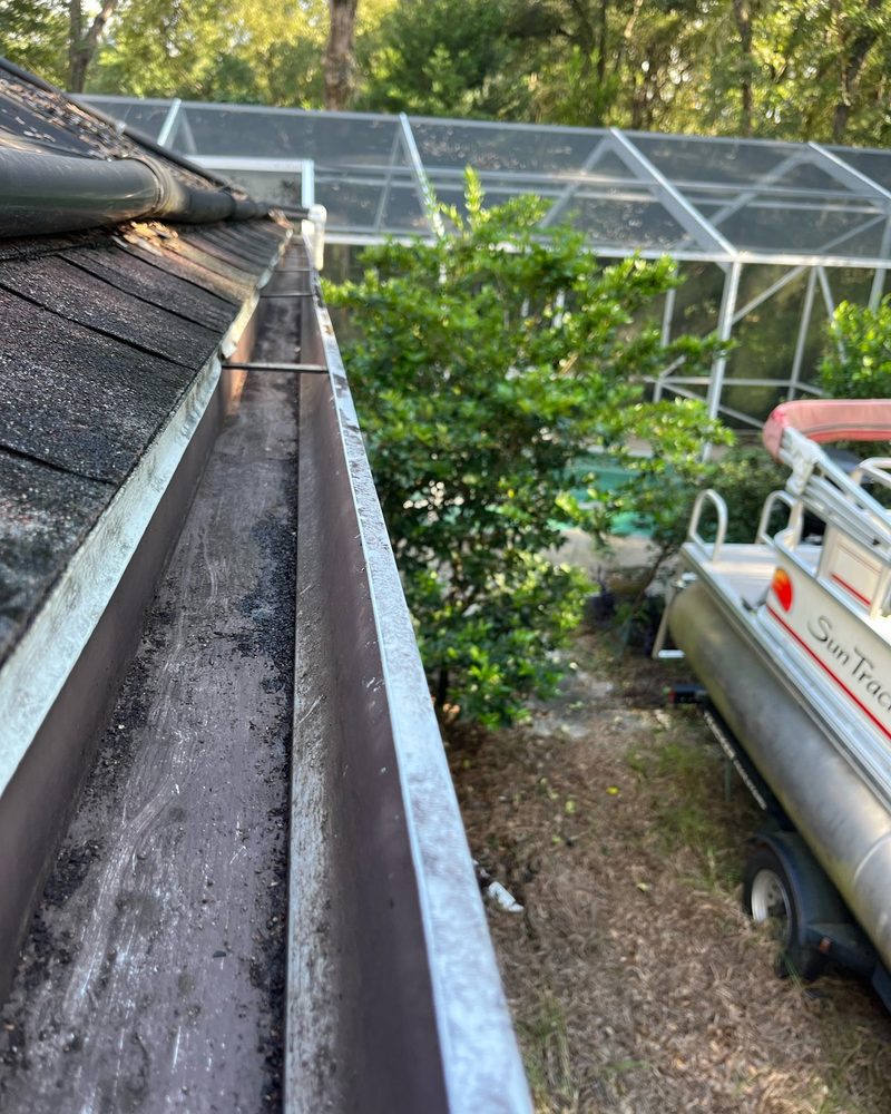 Leaf-clogged gutter after cleaning by H&S Home Services