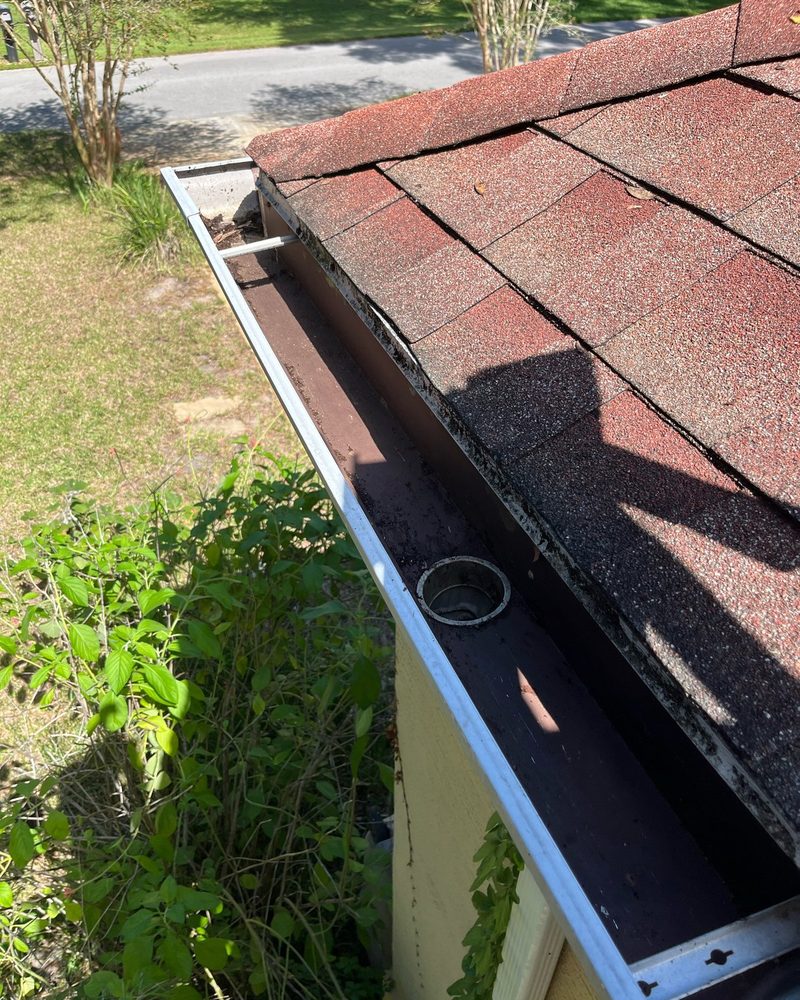 Leaf-clogged gutter after cleaning by H&S Home Services