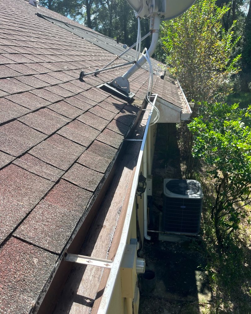 Debris-filled gutter after cleaning by H&S Home Services