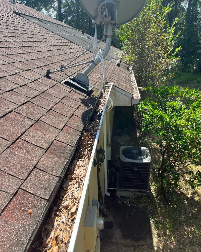 Debris-filled gutter before cleaning