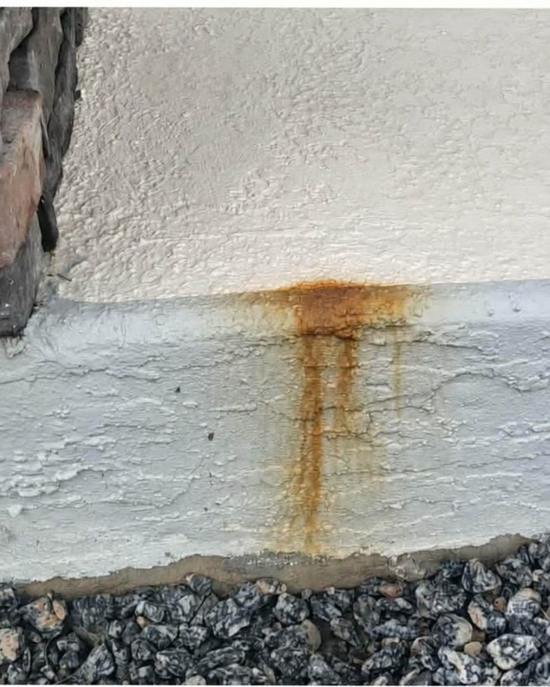 Rust stain on an exterior ledge before cleaning