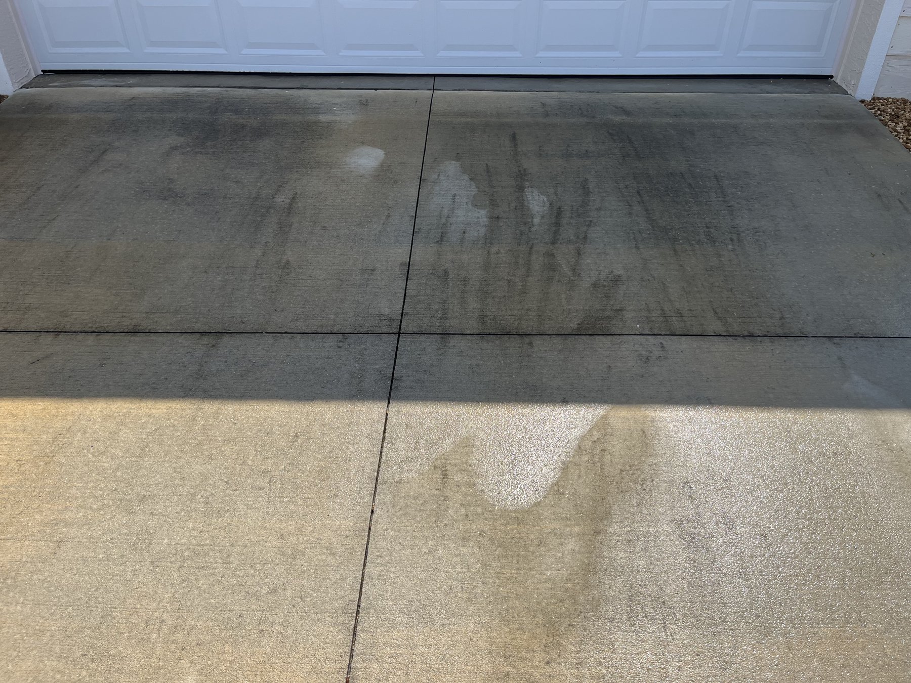 Garage driveway before surface cleaning — dirty concrete slabs