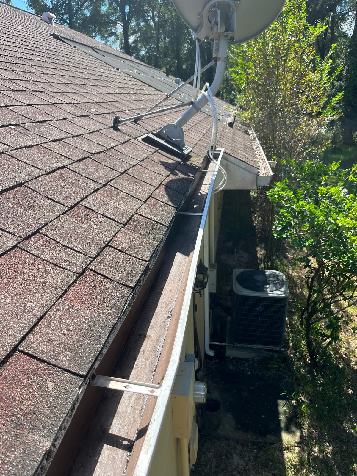 Gutter after — cleared white gutter near satellite dish and AC unit