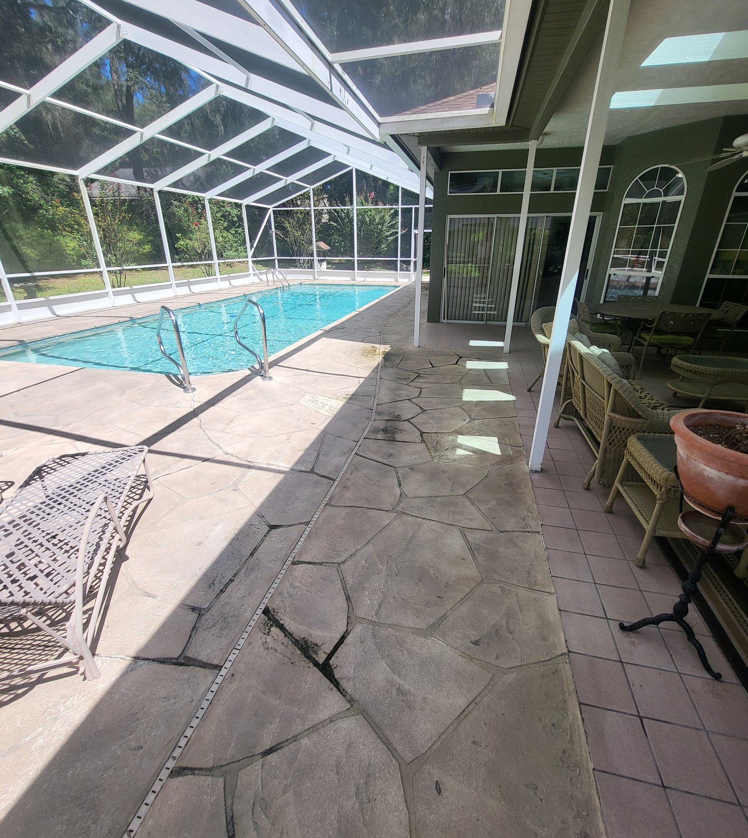 Pool deck and lanai floor before — dirty stamped cool deck around pool