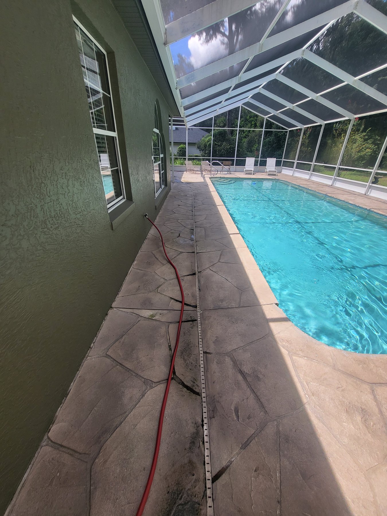 Stamped pool deck before cleaning — stained cool deck