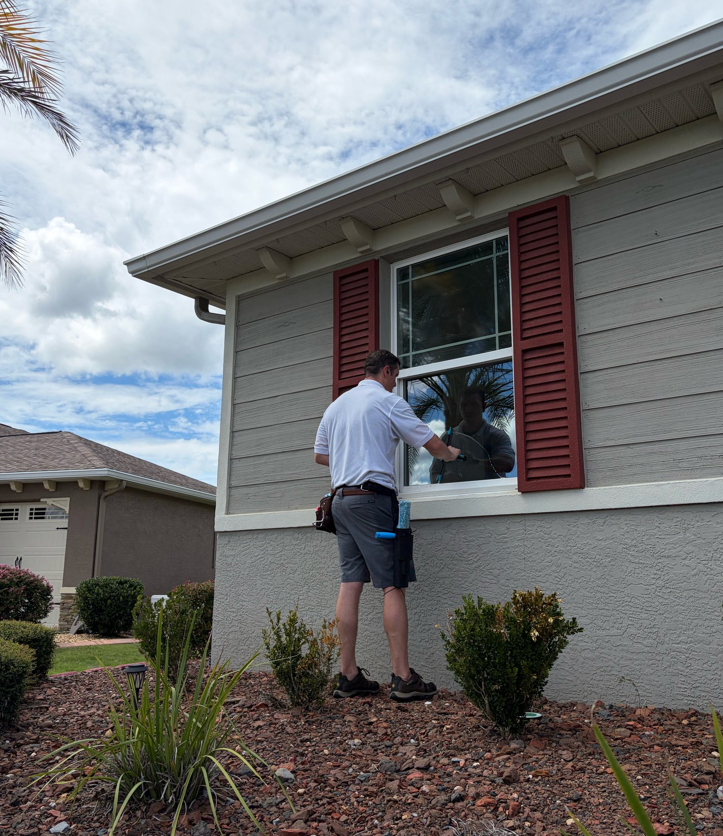 Window cleaning in progress — squeegee on shuttered window
